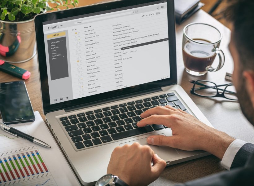 emails list on a laptop screen office background.jpg